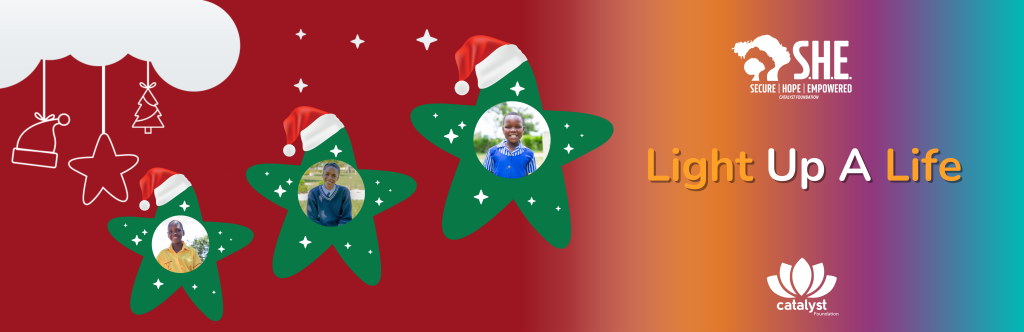 A Christmas banner for the "Light Up A Life" campaign, featuring three festive green stars wearing Santa hats. The center of each star contains a close-up photo of a smiling S.H.E. beneficiary. Text reads "Light Up A Life."
