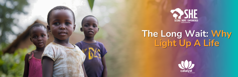 A banner with three young, smiling children, promoting the blog post/campaign "The Long Wait: Why Light Up A Life." The background has an orange-to-teal gradient and includes the S.H.E. and Catalyst Foundation logos.