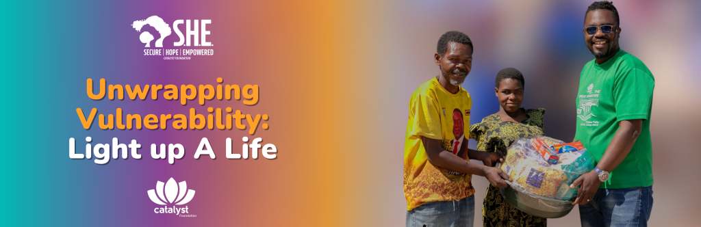 Option 2 (Concise & Campaign-Focused): A S.H.E. beneficiary receiving a large food hamper from Catalyst Foundation staff, promoting the "Unwrapping Vulnerability: Light up A Life" Christmas campaign.