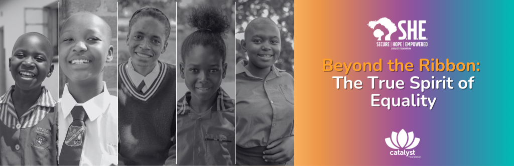 A wide horizontal banner featuring a series of black-and-white portraits of five smiling young girls on the left side. The right side has a vibrant orange-to-teal gradient background with the headline "Beyond the Ribbon: The True Spirit of Equality". The Catalyst Foundation logo and the S.H.E. (Secure Hope Empowered) program logo are prominently displayed at the top and bottom right.
